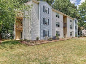 Suffolk apartment for rent - the back of a white house with a yard and trees