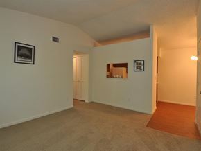 Suffolk apartment for rent - a living room with white walls and a door to a bathroom
