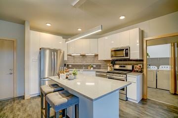Verona apartment for rent - a kitchen with white cabinets and stainless steel appliances