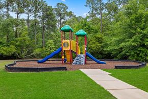 Biloxi apartment for rent - A playground with a blue slide and a yellow and red structure.