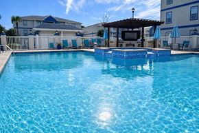Biloxi apartment for rent - A large swimming pool with a pavilion and lounge chairs.
