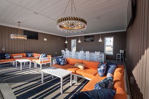 Knightdale apartment for rent - a lounge area with orange couches and tables and chairs