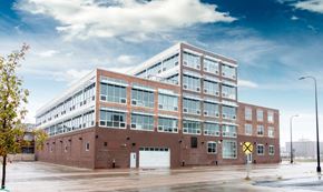 Sioux City apartment for rent - a large brick building with a white garage door