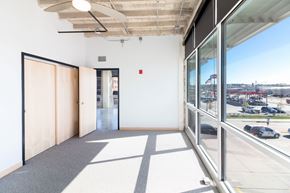 Sioux City apartment for rent - a room with a large window and a door and a view of a street