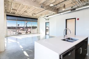 Sioux City apartment for rent - a large white kitchen with a sink and a window