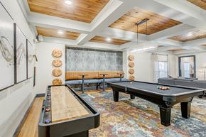 Coppell apartment for rent - a game room with two shuffleboards and a pool table