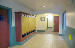 Oakland apartment for rent - a hallway with lockers and doors in a building