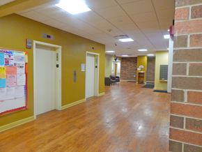 Evanston apartment for rent - a large room with a wood floor and a brick wall