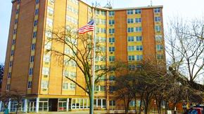 Wheeling apartment for rent - an flag in front of a tall building
