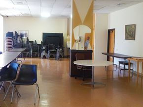 Wheeling apartment for rent - a dining room with tables and chairs and a piano