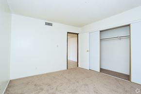 Las Vegas apartment for rent - A room with a carpeted floor and a door leading to another room.