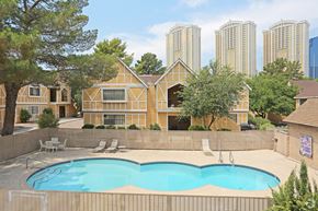 Las Vegas apartment for rent - A pool in a backyard with a house in the background.