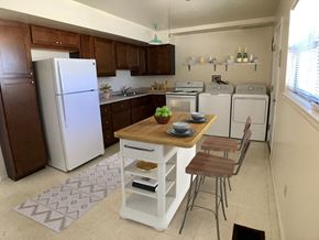 Rantoul apartment for rent - a kitchen with white appliances and a wooden table with two chairs