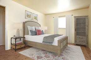 Rantoul apartment for rent - a bedroom with a bed and a dresser and a window