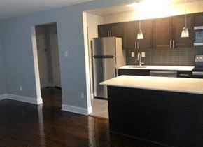 Philadelphia apartment for rent - A kitchen with a black counter and a white fridge.