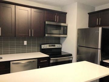 Philadelphia apartment for rent - A kitchen with a white counter top and stainless steel appliances.