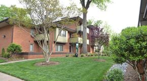 Charlotte apartment for rent - an apartment building with green grass and trees