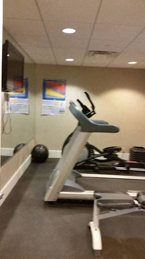 Nashville apartment for rent - a gym with a treadmill and weights in it