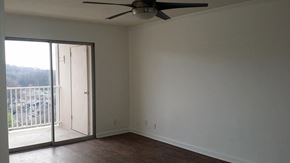 Nashville apartment for rent - an empty living room with a ceiling fan and a sliding glass door