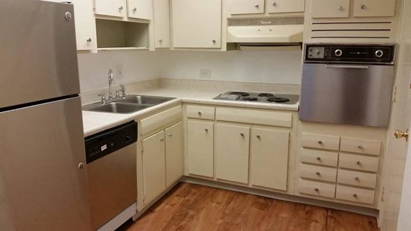 Nashville apartment for rent - a kitchen with white cabinets and stainless steel appliances