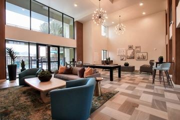 Phoenix apartment for rent - A spacious living room with a large rug and a variety of seating options.