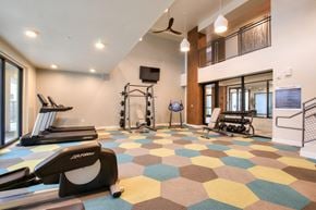 Phoenix apartment for rent - A gym with a treadmill, weights, and exercise equipment.