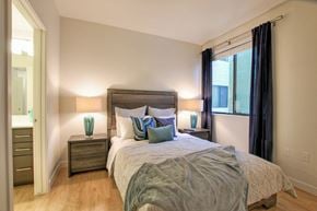Phoenix apartment for rent - A bedroom with a large bed and two nightstands with lamps.