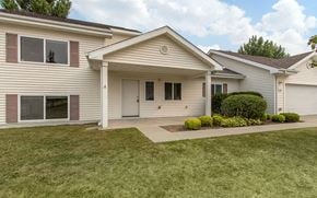 Grand Forks Afb apartment for rent - the front of a white house with a driveway and grass