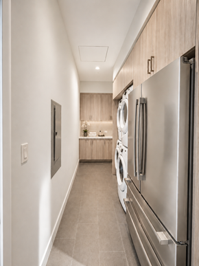 Dallas apartment for rent - A modern kitchen with a stainless steel refrigerator and a washing machine.