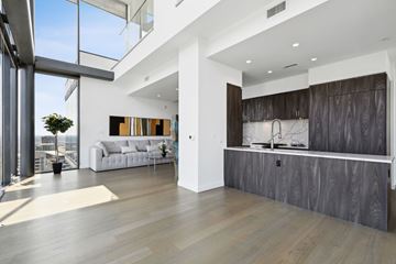 Dallas apartment for rent - A modern living room with a white couch and a large window.