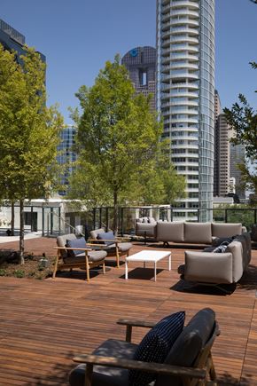 Dallas apartment for rent - a rooftop deck with furniture and trees and skyscrapers