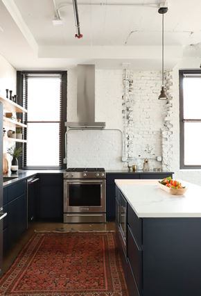 Milwaukee apartment for rent - A kitchen with a white brick wall and a stainless steel oven.