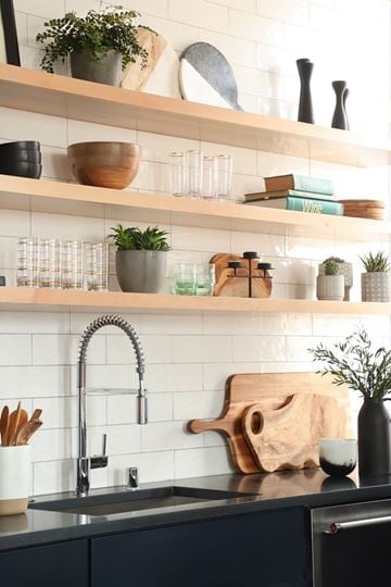 Milwaukee apartment for rent - A kitchen with a black counter and a wooden cutting board.