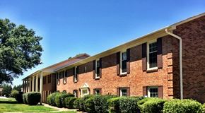 Rock Hill apartment for rent - a large brick building with a tree in front of it