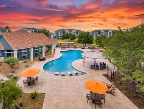 San Antonio apartment for rent - an aerial view of a swimming pool and patio with umbrellas