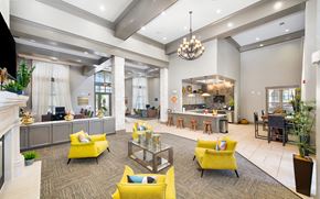 San Antonio apartment for rent - a large lobby with yellow chairs and a kitchen