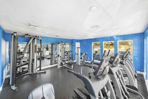 Austin apartment for rent - A gym with a variety of equipment including treadmills, weights, and exercise machines.