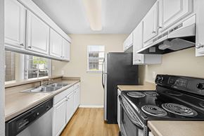 Austin apartment for rent - A kitchen with a black stove top oven.
