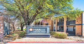 Austin apartment for rent - A sign for MAA Balcones Woods is in front of a building.