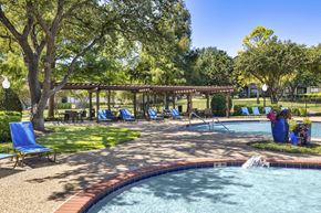 Roanoke apartment for rent - A pool with a waterfall and a pavilion in the background.