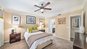 Fairview apartment for rent - a bedroom with a ceiling fan and a bed