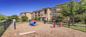 Carrollton apartment for rent - an apartment building with a playground and a tent