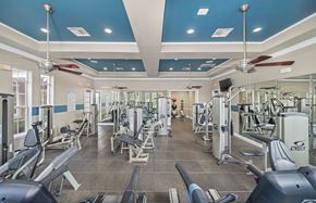 Austin apartment for rent - a gym with cardio equipment and ceiling fans