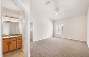 Round Rock apartment for rent - an empty bedroom and bathroom with a sink and a ceiling fan