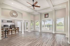 Irving apartment for rent - A spacious room with a ceiling fan and wooden flooring.