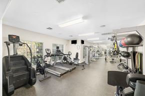 Round Rock apartment for rent - A gym with a variety of equipment including treadmills, weights, and exercise machines.