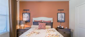 Roanoke apartment for rent - a bedroom with a bed and orange walls
