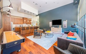 Dallas apartment for rent - a living room with a couch and a ping pong table