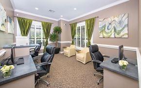San Antonio apartment for rent - a conference room with two desks and chairs and windows with green curtains