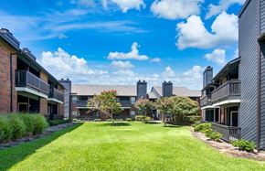 Plano apartment for rent - a grassy yard between two apartment buildings